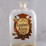 Here's an alt tag for the image: Antique Lumbric Alum glass bottle.