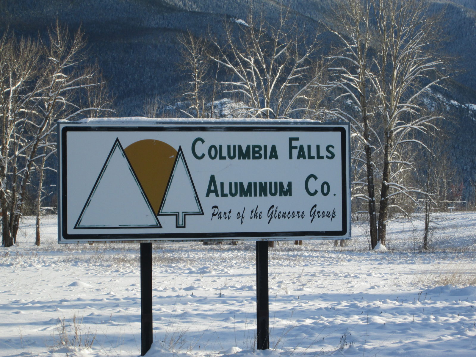 A sign in the snow that says columbia falls aluminum co.